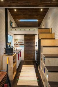 Farmhouse double galley kitchen with wooden accents and dual counters.
