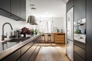Double galley kitchen with open shelving and wood accents.