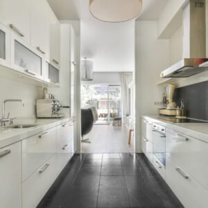 Double galley kitchen with marble backsplash and island